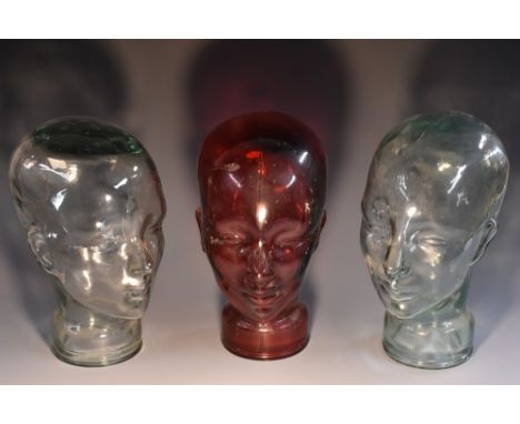 A 20th century moulded pressed clear glass mannequin head, 29cm high;  another;  etc (3)