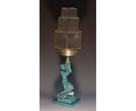 An Art Deco table lamp, the frosted green glass base (later over painted) moulded as a scantily clad beauty, frosted clear gl