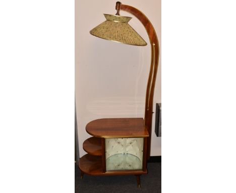 An Art Deco combination cabinet lamp-stand. The figured mahogany base with waterfall bookcase to one side and adjacent cabine