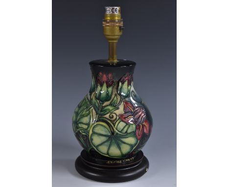 A contemporary Moorcroft Trial baluster lamp base, designed by Shirley Haynes, tube lined with stylised lilies and pads, in t