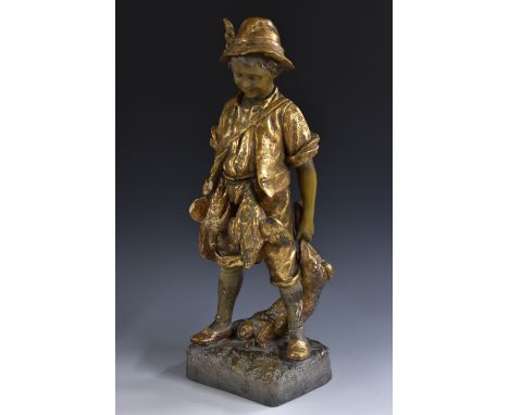 A Goldscheider figure, of a young Romany hunter, with dead game hanging from his belt and holding a hare, gilded, rounded rec