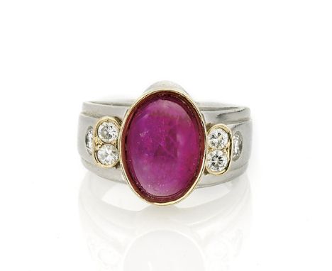 18K YELLOW GOLD RUBY CABOCHON RING18K yellow gold and platinum ring; centering an unheated Tajikistan ruby cabochon in a beze