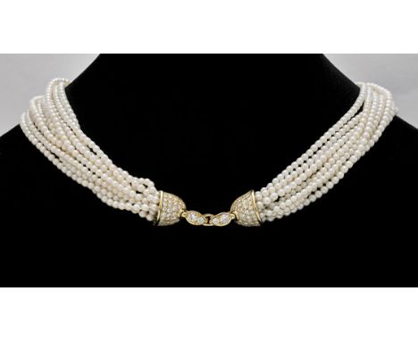 PEARL TORSADE NECKLACEVintage-style, nine-strand pearl torsade necklace; the baby pearls of creamy white coloration with a so