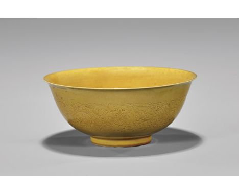ANTIQUE MONOCHROME YELLOW BOWLAntique Chinese monochrome yellow glazed porcelain bowl; of flared footed form, with an incised
