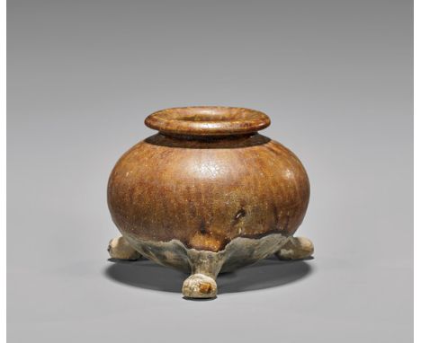 TANG DYNASTY GLAZED TRIPOD VESSELSmall Chinese Tang Dynasty, amber glazed pottery tripod vessel; of squat bulbous form with a