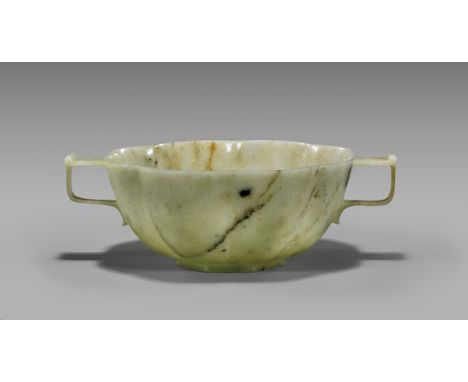 17TH CENTURY CHINESE JADE BOWLLarge and well carved, antique Chinese jade bowl; of scalloped form, with two handles and set o