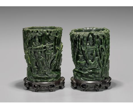 PAIR FINE SPINACH JADE BRUSHPOTSPair of finely carved, Chinese spinach jade brushpots; the cylindrical forms each with contin