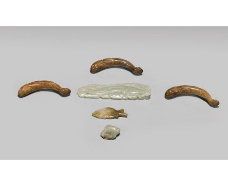 SIX ANTIQUE CARVED JADE FISH TOGGLESSet of six, antique Chinese carved jade fish toggles: three reddish-brown arced swimming 