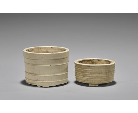 TWO ANTIQUE PORCELAIN CENSERSTwo antique Chinese crackle glazed, tripod censers, each with ribbing: taller of lighter colorat