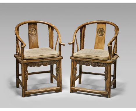 PAIR ELMWOOD HORSESHOE-BACK CHAIRSPair of antique 19th century Chinese elmwood horseshoe-back armchairs; each central splat w