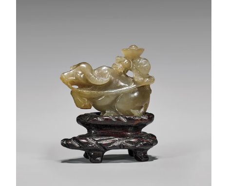 ANTIQUE BUFFALO JADE TOGGLEAntique Chinese carved, translucent tan-gray jade toggle; of a figure with hat riding a buffalo kn