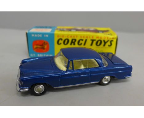 A Corgi no.253 Mercedes 220SE Coupe with blue body and lemon interior, luggage in boot, spare wheel and spring suspension 