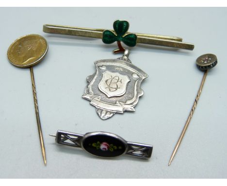 A silver and enamel brooch, a shamrock tie pin, an old cut diamond set pin, a coin pin and a silver fob medal 