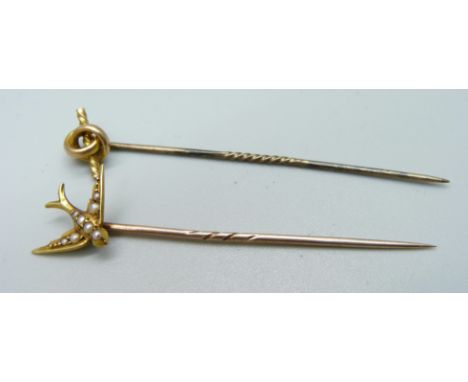 A stick pin, the top marked 15ct, and a pearl set swallow stick pin 