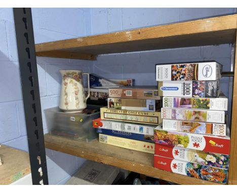Shelf of Jigsaws and a ewer