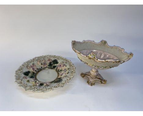 A Capodimonte porcelain charger, the pierced border with relief moulded figural decoration, 36cm diameter and a table centrep