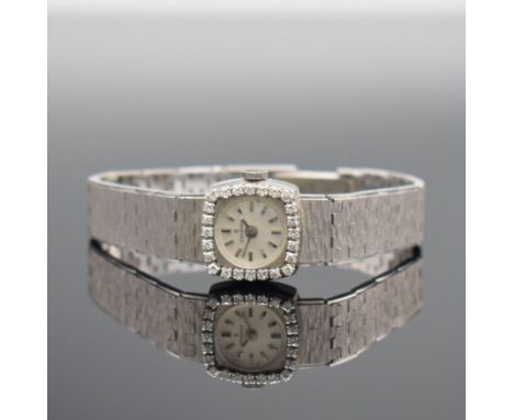 CANDINO Damenarmbanduhr mit Diamantbesatz in WG 750/000,  Schweiz um 1970, Handaufzug, Boden aufgedr., Geh. an Goldband 750/0