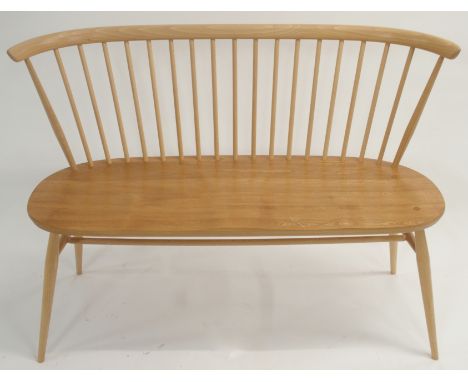 A LIGHT ERCOL STICK BACK BENCH on tapered legs with turned stretcher, 82cm high x 112cm wide x 42cm deep Condition Report: Av