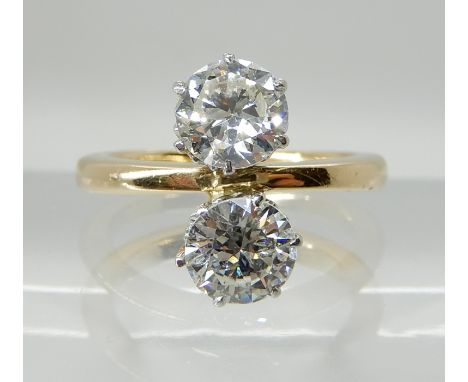 A BRIGHT YELLOW AND WHITE METAL TWIN STONE DIAMOND RING both diamonds are estimated at approx 0.80cts each with a total carat