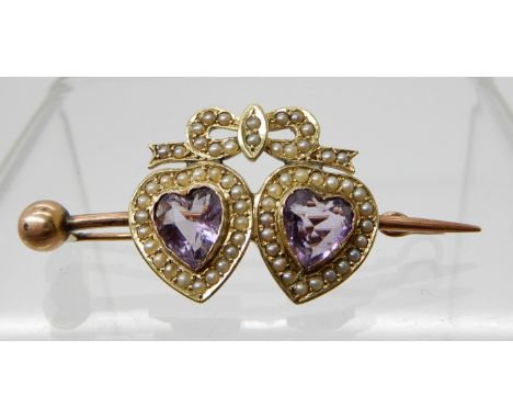 A YELLOW METAL TWIN AMETHYST HEART AND SEED PEARL BROOCH length 4.5cm, weight 4.4gms Condition Report: Available upon request