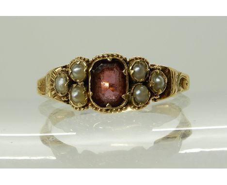 A BRIGHT YELLOW METAL VICTORIAN GARNET AND PEARL SET RING with engraved shoulders and shank, size P, weight 1.5gms Condition 
