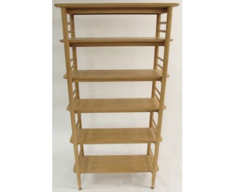 A LIGHT OAK ERCOL TERAMO SHELVING UNIT with open overhanging shelves, 185cm high x 95cm wide x 36cm deep and an Ercol circula