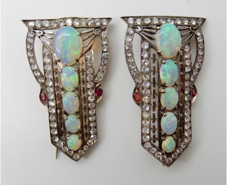 A PAIR OF ART DECO OPAL SET BROOCHES set in yellow and white metal further set with clear and red paste gems to the pierced b