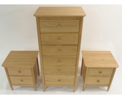 A LIGHT ERCOL TERAMO NARROW SIX DRAWER CHEST with tapered legs, 140cm high x 63cm wide x 47cm deep with two matching two-draw