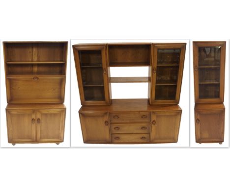 AN ERCOL GOLDEN DAWN DISPLAY CABINET with open shelves flanked by two glazed cabinets over a base with three drawers flanked 