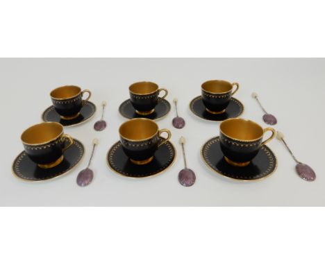 A SET OF SIX ROYAL WORCESTER DEMITASSE CUPS AND SAUCERS circa 1915, the black ground with gilt scalloped decoration, gilt han