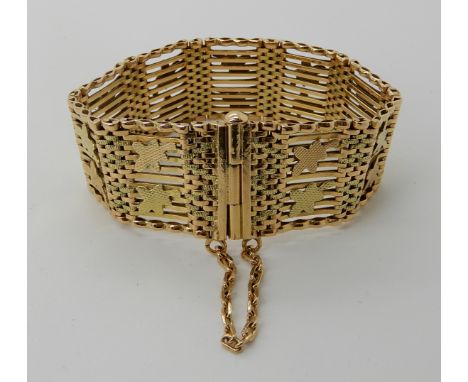 A BRIGHT YELLOW METAL GATE BRACELET WITH BI-COLOUR LEAF DESIGN dimensions 17cm x 2.3cm, weight 49.7gms Condition Report: Ligh