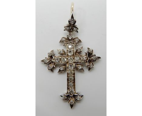 A VICTORIAN OLD CUT DIAMOND CROSS craftsman made in yellow and white metal the foliate design cross is set with estimated app