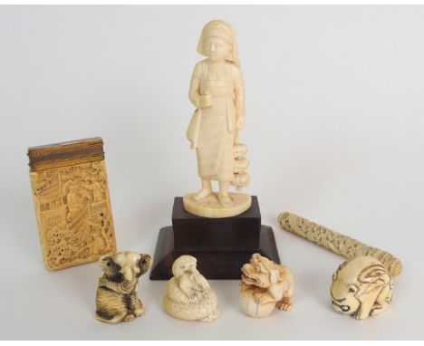 A CHINESE IVORY CARD CASE carved all over with figures amongst balconies and trees, later brass cover, 7.5cm high, ivory need