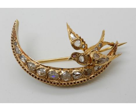 A CONTINENTAL YELLOW METAL CRESCENT MOON AND SWALLOW BROOCH both set with rose cut diamonds the swallow has a ruby eye. Dimen