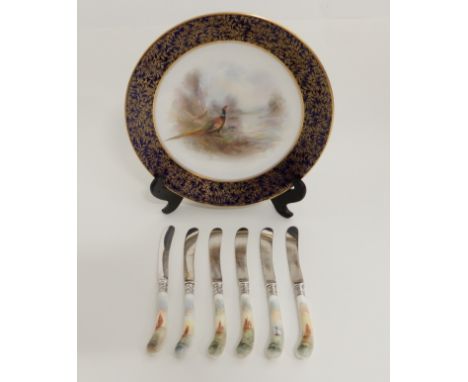 A JAMES STINTON ROYAL WORCESTER PLATE circa 1908, painted with a male and female pheasant in a landscape setting, 23cm diamet