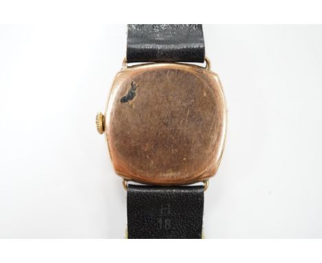 A gentleman's 1930's yellow metal manual wind wrist watch, with Arabic dial and subsidiary seconds, on a later leather strap.