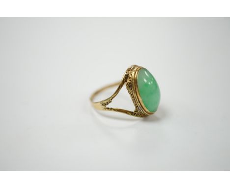 A Chinese 18k and cabochon jade set ring, size O, gross weight 3.9 grams. Condition - poor
