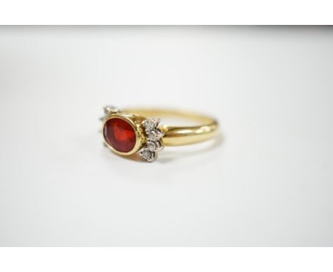A modern 18ct gold, single stone fire opal? and eight stone diamond chip set dress ring, size L/M, gross weight 5.3 grams. Co