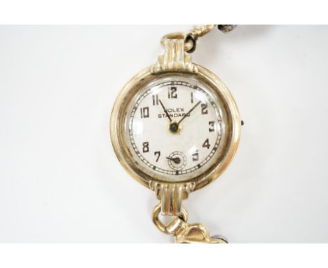 A lady's gilt metal manual wind wrist watch, the dial inscribed 'Rolex Standard', movement unsigned and no winding crown, on 