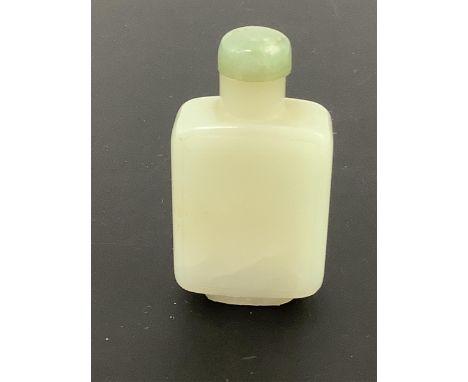 A Chinese pale celadon jade snuff bottle, 19th century, of rectangular form with a raised panel to each side, the stone with 