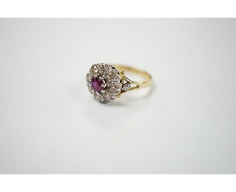 A yellow metal ruby and diamond cluster set flower head ring, size I/J, gross weight 3.6 grams. Condition - fair