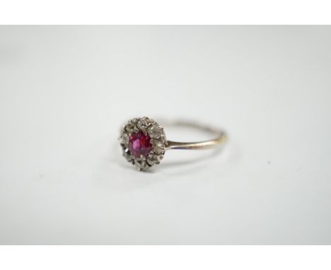 A 1940's 18ct white metal, ruby and diamond set circular cluster ring, size N/O, gross weight 1.9 grams. Condition - fair
