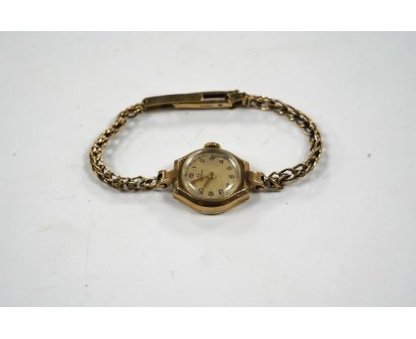 A lady's 9ct gold Omega manual wind wrist watch, on an associated 9ct bracelet, gross weight 12.8 grams. Condition - poor to 