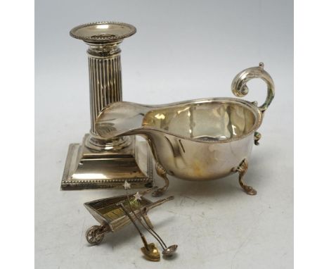 A late Victorian silver dwarf candlestick by Edward Hutton, London, 1893, 12.8cm, a silver sauceboat and three other items. C