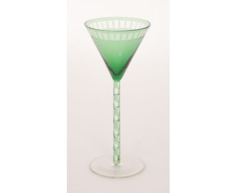 A stemmed wine glass circa 1906 designed by Otto Prutscher for Meyr's Neffe with a circular spread foot below a green cased a