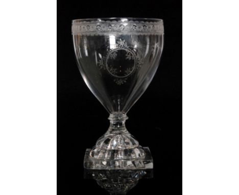 A large clear crystal glass rummer circa 1800 with pointed funnel bowl engraved with a central floral cartouche below a runni