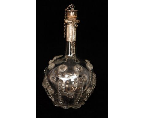 An early 19th Century Continental crystal glass decanter, spherical body with slender collar neck below applied metal mounts,