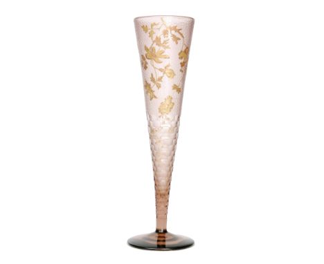 A large late 19th Century Harrach oversized pale cinnamon lily vase of footed conical form, the upper body relief gilded with