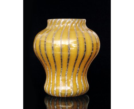 A 1930s Monart shape C vase of inverted baluster form with collar neck decorated with an amber/yellow lustre over an opal bas