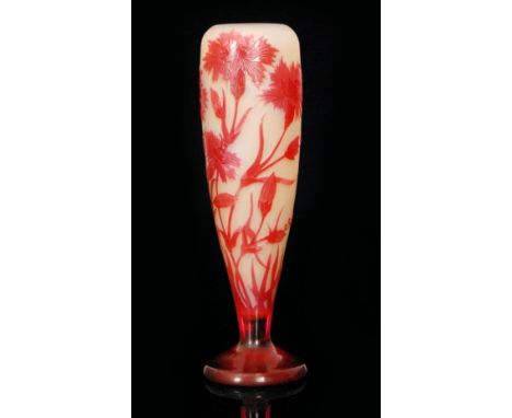 An Emille Galle cameo glass vase of slender foot form, cased in ruby over pale citron and cut with flowering carnations, came